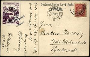 77,Spitsbergen etikett nr 18. 10 øre posthorn på postkort til Tyskland, stemplet "Hammerfest 19.7.09". Ved siden påsatt en lilla "Österreischer Lloyd Thalia"-etikett som er stemplet "Advent-Bay Spitzbergen".