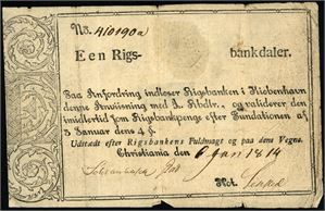 Een Rigsbankdaler, Christiania 1814, No. 410190a. Også en 12 skilling, Christiania 1810. Begge påsatt tape på baksiden for montering i album samt noen andre anmerkninger.