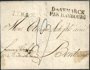 Komplett brev fra Drammen 23 juni 1823 til Bordeaux, påskrevet "franco Hamburg via Fredrikshavn" i nedre venstre hjørne, og stemplet "Danemarck Par Hambourg" og "T.T.R.4" på forsiden. Baksiden med kartering "131" samt porto "35" Rbs. Satt i porto med 19 decimes. En liten fettflekk på høyre side.